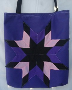 4. Purple bag with black, pink and purple star design.
