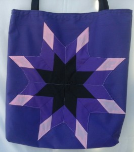 2. Purple bag with a black, purple and pink star.