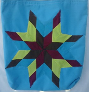 4. Blue bag with burgundy, brown, yellow and light blue