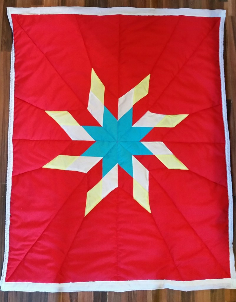 Red Star Blanket with yellow, red, turquoise, and white star.