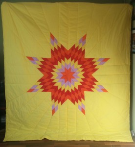 Yellow Star Blanket with orange, light purple, red, and yellow star.