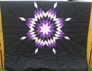 1. Black blanket with White, purple, and black star.