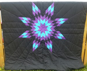 2. Black blanket with purple, turquoise, and black blanket.