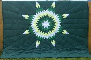 45. Green blanket with white, yellow, and green star.