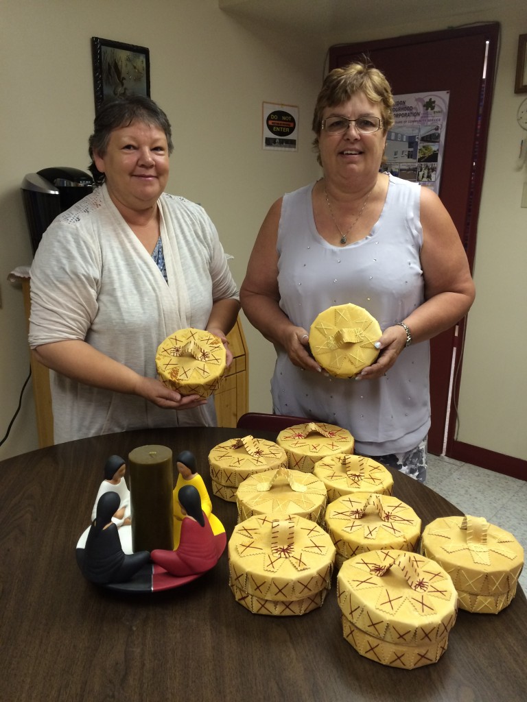 Gail Cullen- Executive Director of Brandon Friendship Center holding Birch Bark Baskets purchased from Cree Star Gifts.