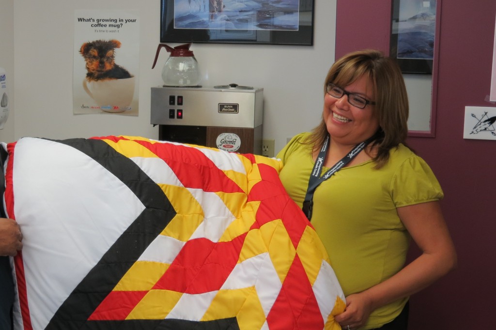 Picture of Gwen Traverse holding one of Cree Star Gifts Blanket