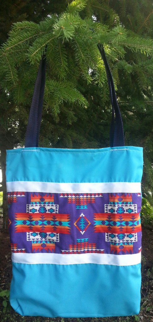 Blue Bag with White Ribbon and Purple Print.