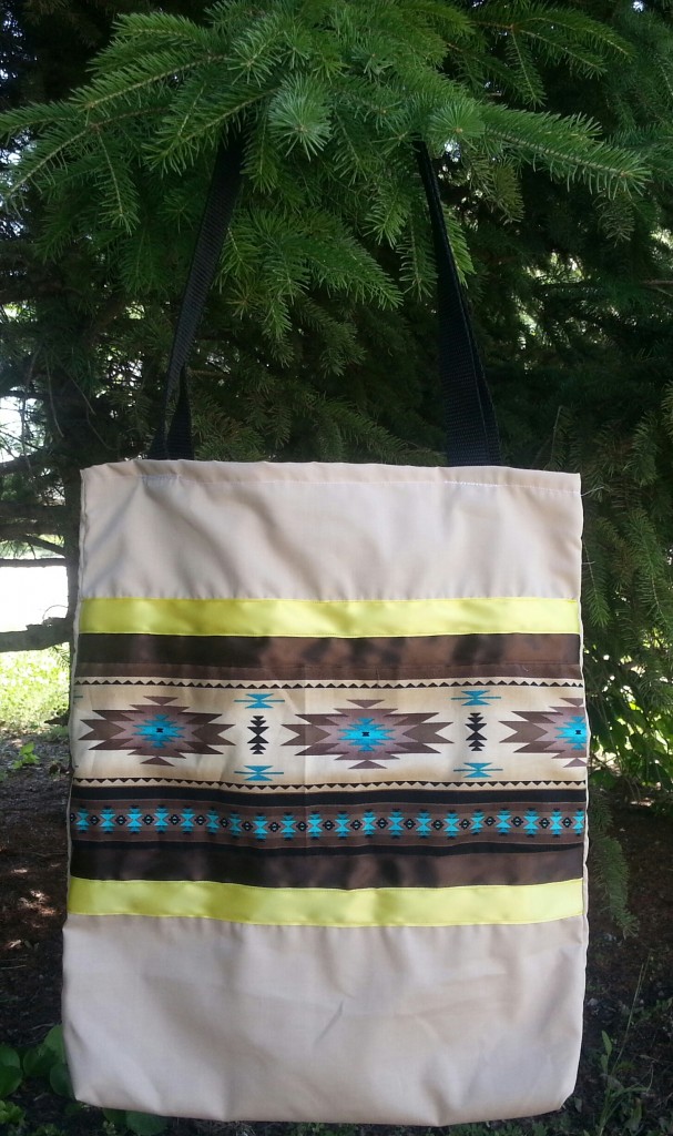 Tan bag with print and brown and yellow ribbon