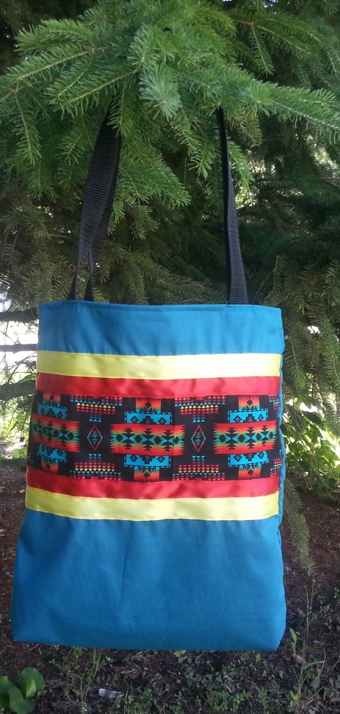 Turquoise bag with print and red and yellow ribbon