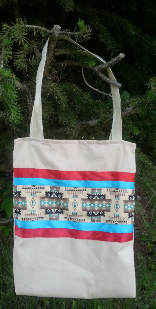 Tan bag with red & blue ribbon.