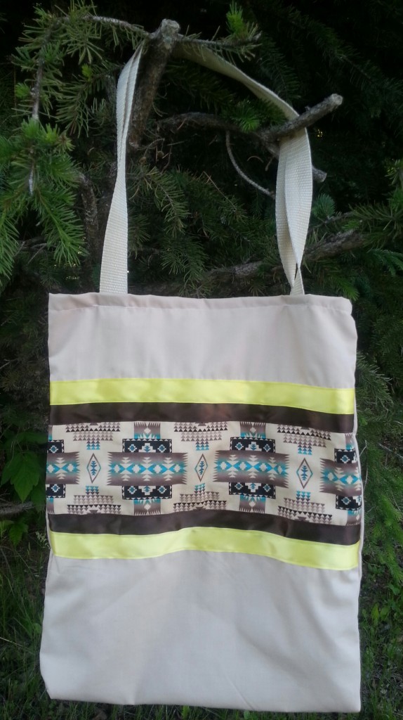 Tan bag with brown & yellow ribbon.