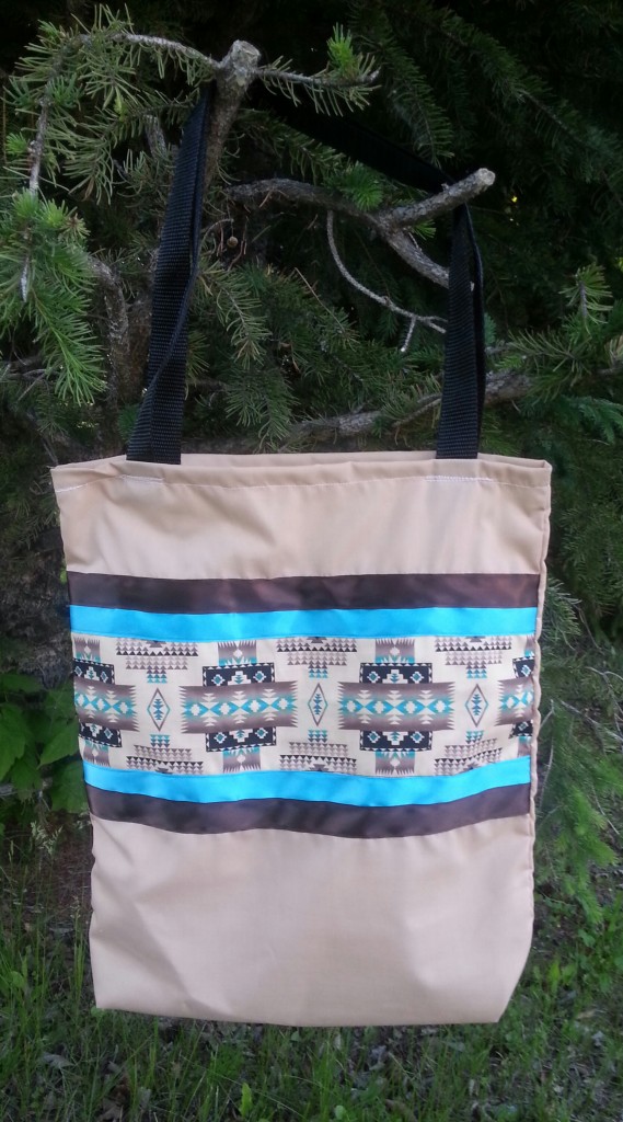 Tan bag with blue & brown ribbon.