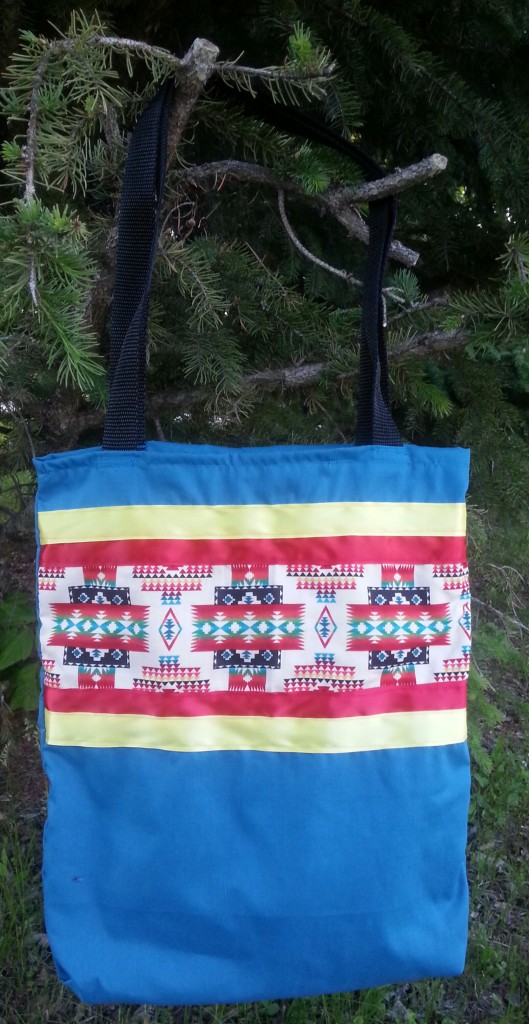 Turquoise/blue bag with red & yellow ribbon.